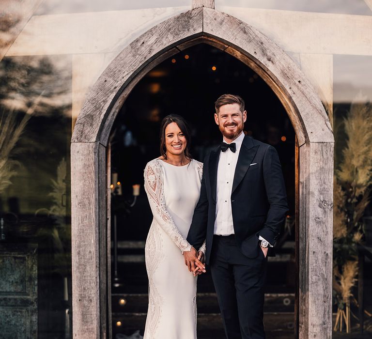 Cute couple portrait of the bride and groom for their rustic winter wedding 