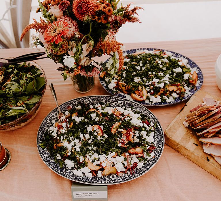 Colourful buffet styled food for wedding reception with Autumnal bridesmaid dresses