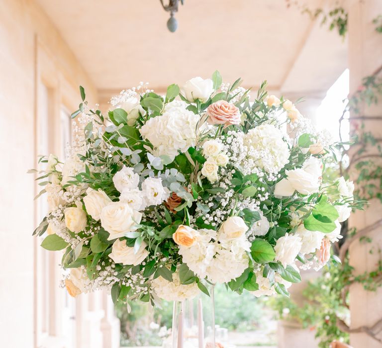 Stunning floral centrepieces for the al fresco wedding reception at the Italian inspired wedding day 