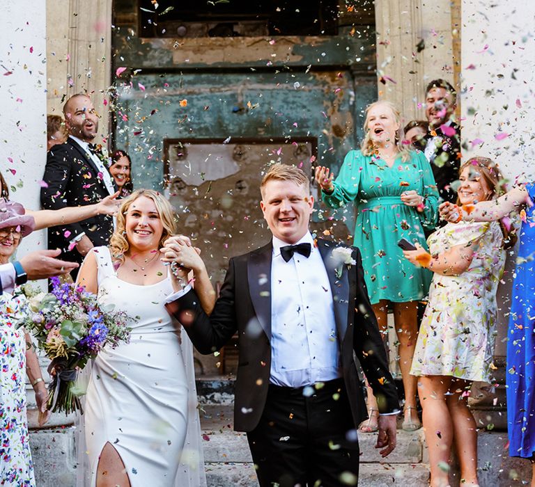 Bride & groom walk through confetti exit at The Asylum Chapel