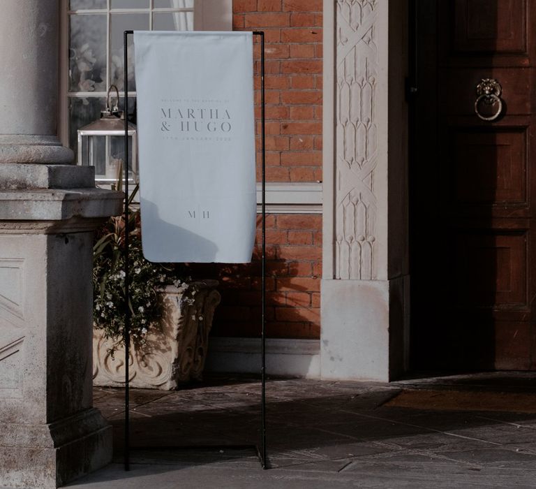 Minimalist white wedding sign on black sign holder at Eaves Hall wedding venue 