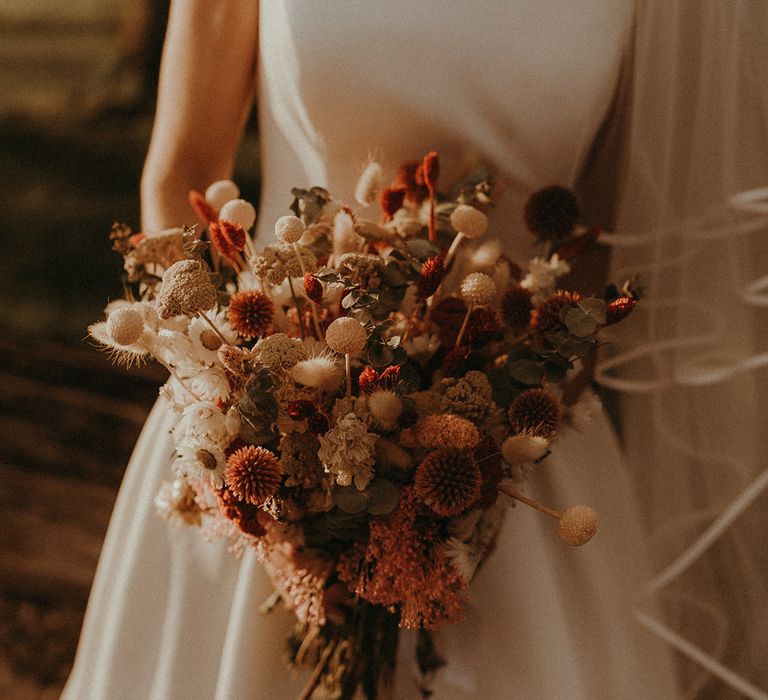 Dried wedding flower bride bouquet in warm orange and white shades for rustic wedding 