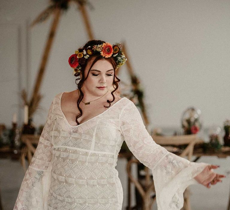 Bride in v-neck long bell sleeve boho wedding dress and boho rustic dried flower crown at The Barn at Avington