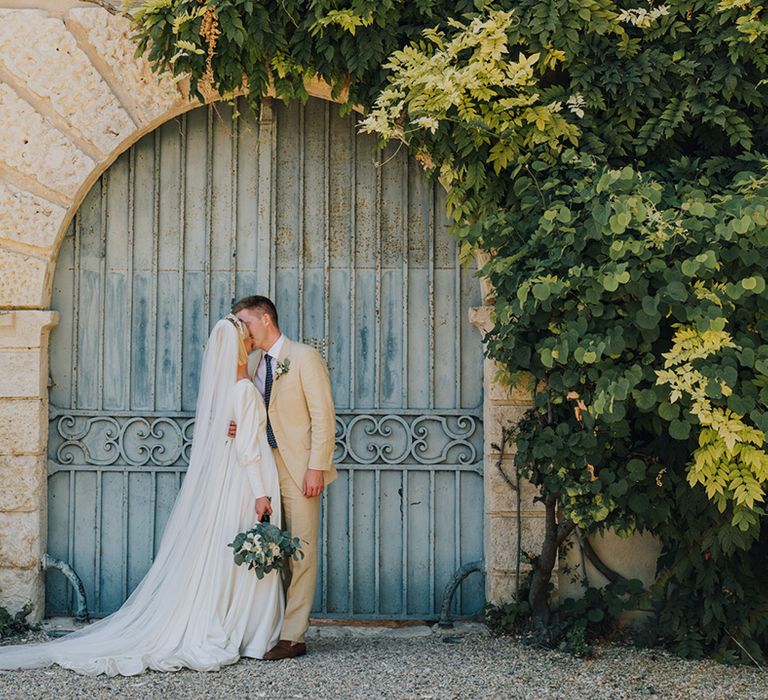 Château de Malliac destination wedding with bride in a long sleeve Emma Beaumont wedding dress and groom in a beige suit