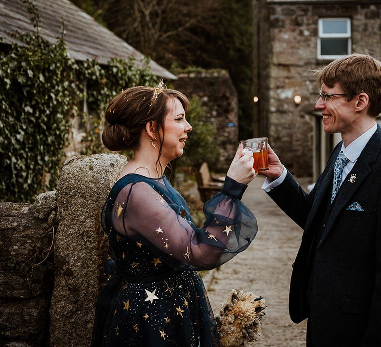 The bride and groom share some drinks together after their wedding ceremony 