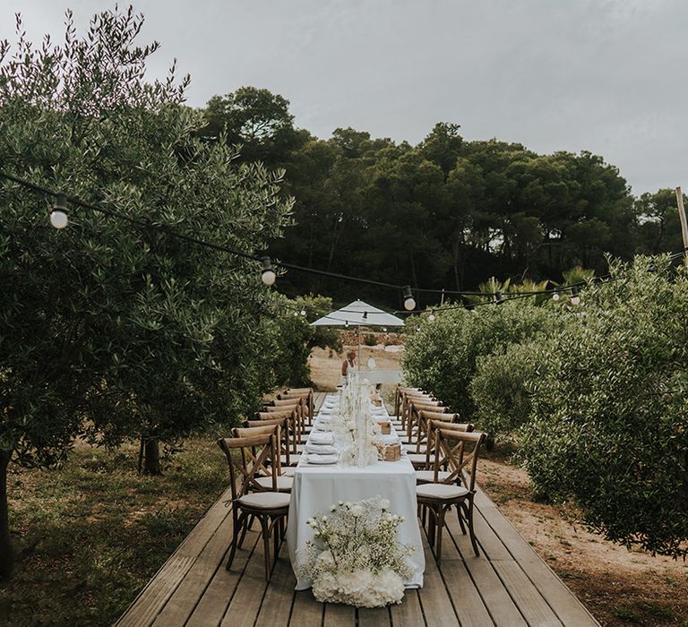 outdoor wedding tablescape at pure house ibiza with all white flower arrangement