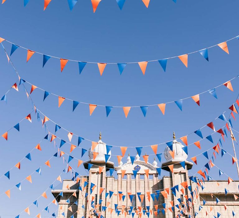 Airplane flying above bunting at English-Indian fusion wedding 