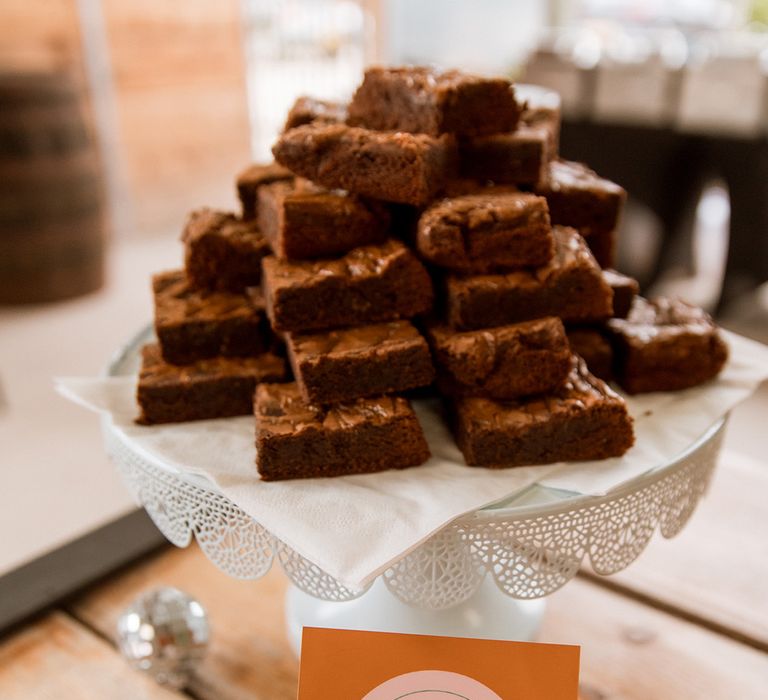 Salted caramel brownies on a white plate on the dessert table 