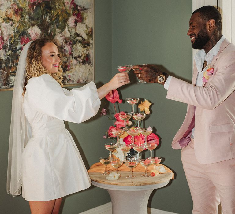 Bride and groom drink from their fun champagne tower at Polstrong Manor 