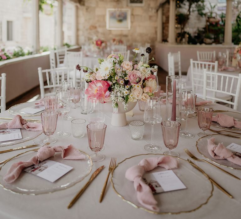 Wedding breakfast at Restaurant Park Hvar with blush tablescape decor, blush and pink peonies and fairy light wedding lighting