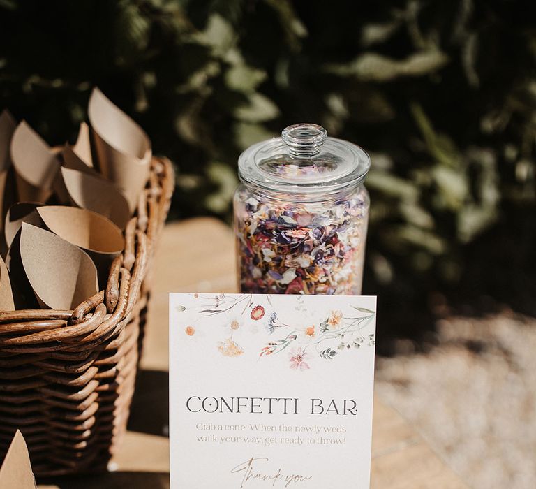 Confetti bar with clear jug filled with dried confetti on wooden table 