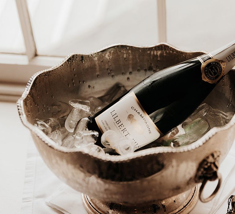 Champagne bottle in ice bucket for the wedding morning 