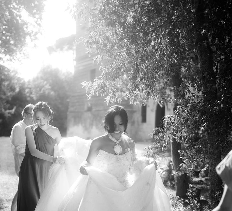 Bride in strapless wedding dress with pearl embellished detailing 