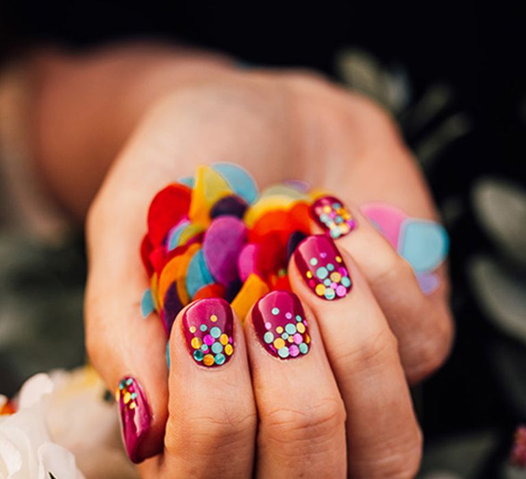 Confetti nails with deep pink base colour 