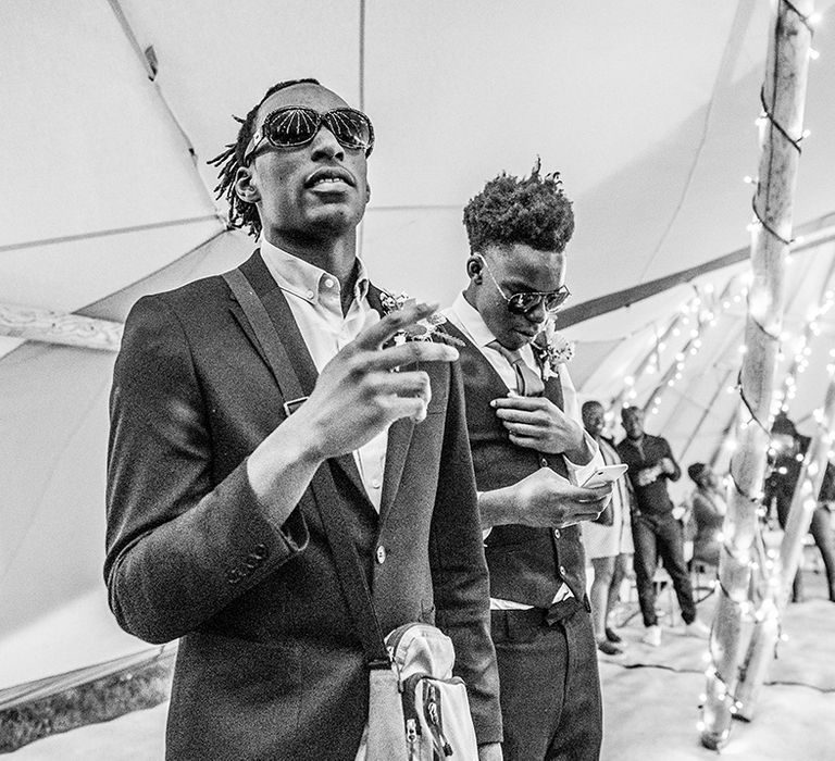 Two wedding guests stand as they vibe to the music at the boho festival wedding 