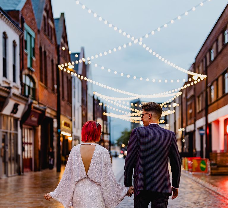 Bride in ASOS high street sequin wedding dress with groom in purple checkered wedding suit 