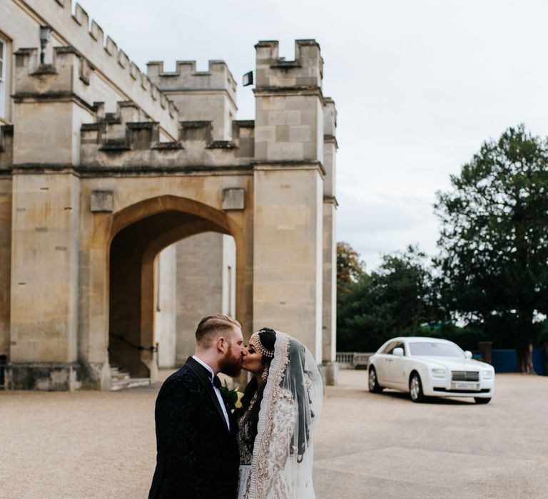 Bride and groom kissing at luxury wedding