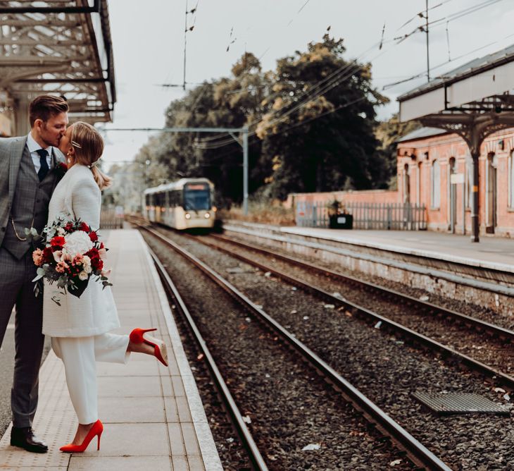 Bride and groom kissing at the tram station for Manchester micro wedding 