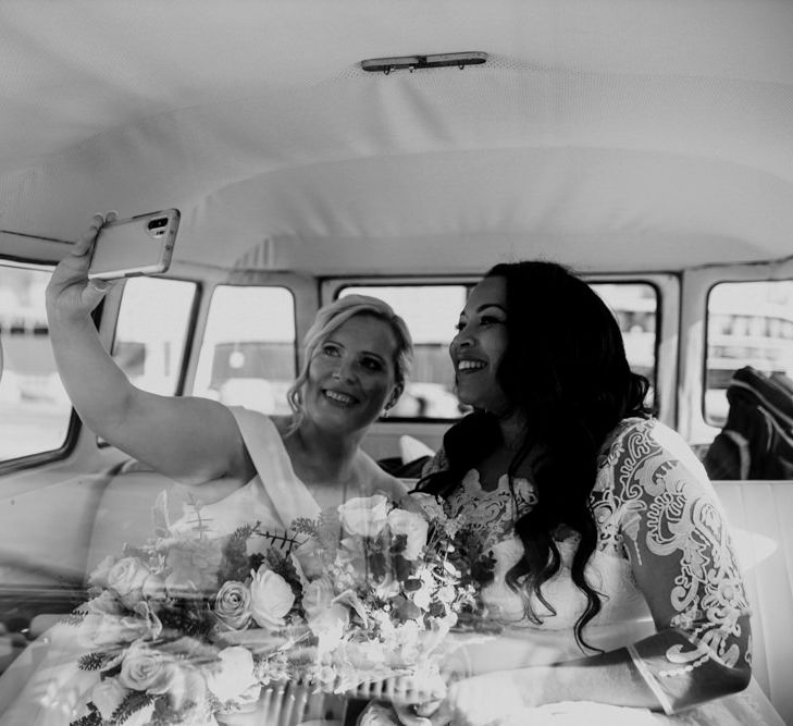 Newly wed lesbian couple taking a selfie - black and white wedding day photography 