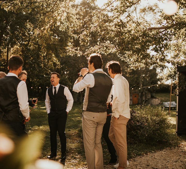 Groomsmen laughing at micro wedding 