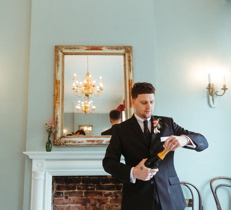 Groom in traditional suit and pink boutonnière