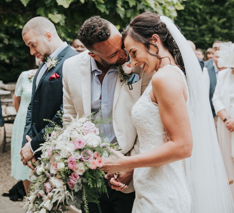 Bride and groom share a coy moment together