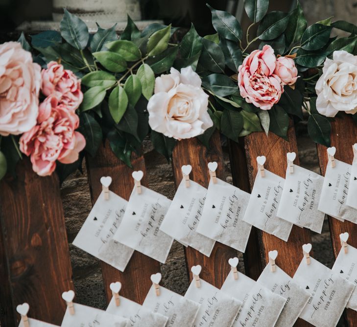 Small envelopes filled with confetti and pegged to a palette