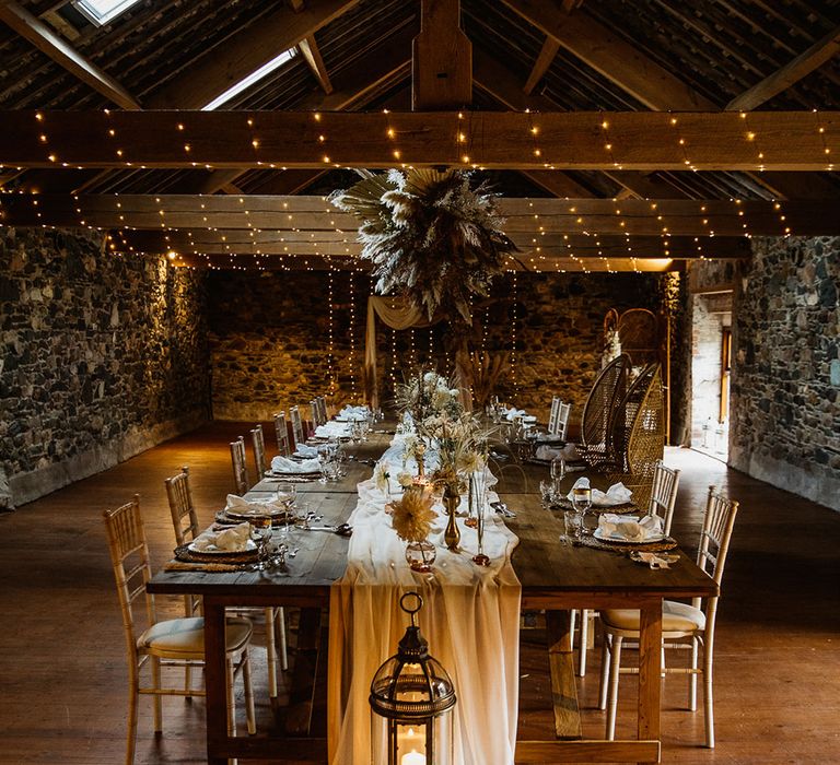 Boho rustic wedding table decoration with pampas flower cloud and bamboo chairs