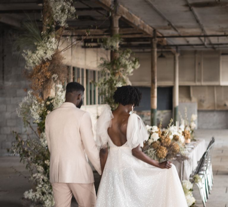 Bride and groom entering the industrial wedding reception 