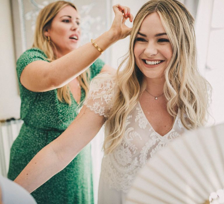 The bride has her hair done at Le Mas De La Rose