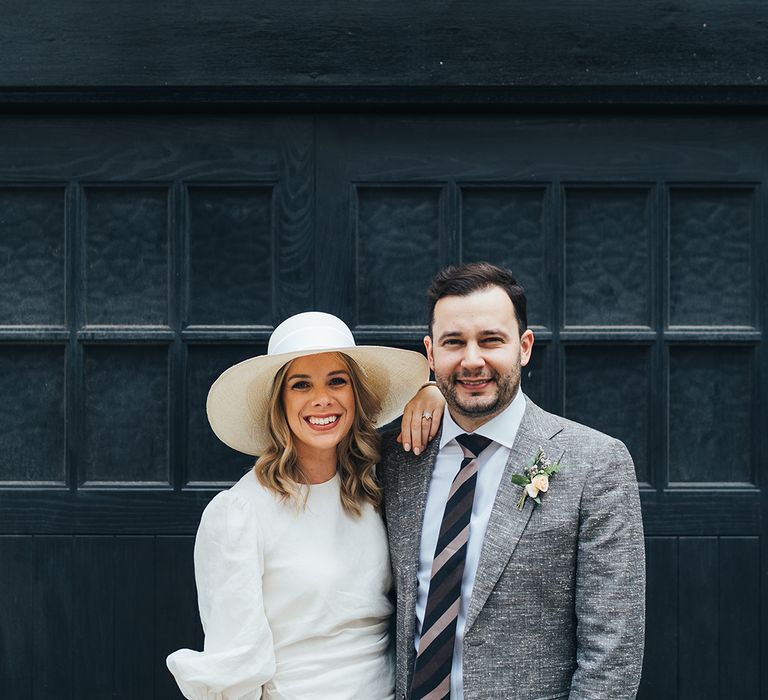 Bride and groom smiling for street photography in Marylebone 