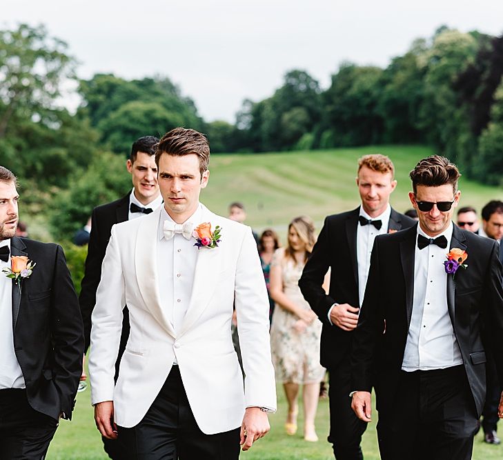 Groom in Tom Ford white tuxedo jacket at fairytale wedding 