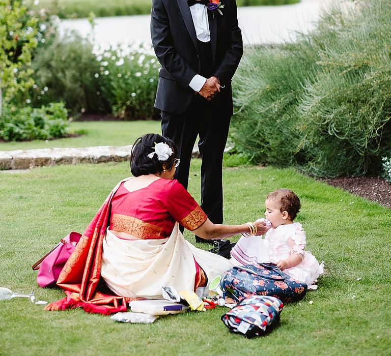 Grandparents looking after the bride and grooms daughter at the black-tie wedding 