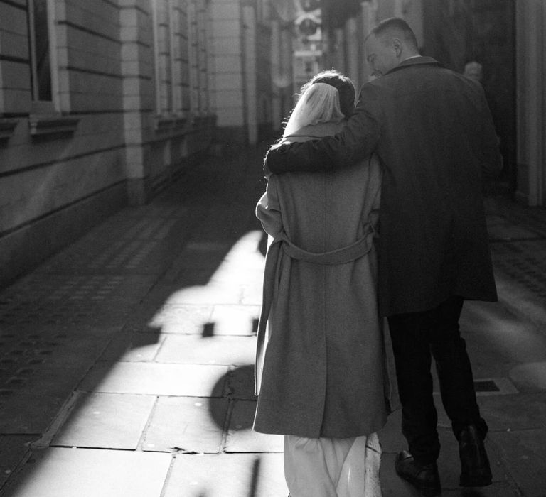 Bride and groom holding each other on London streets for their London elopement