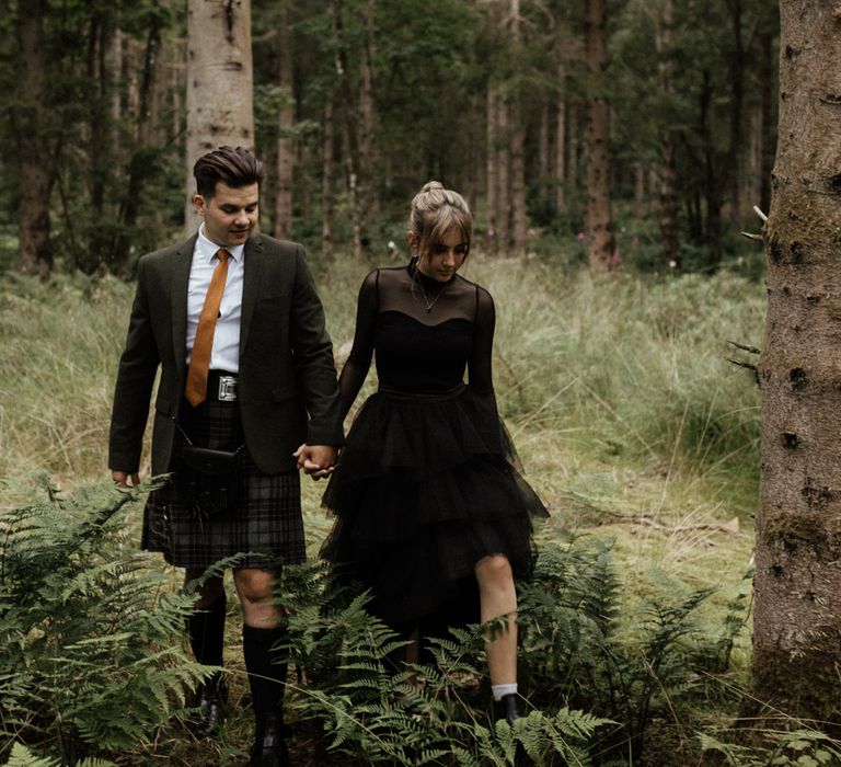 Bride & groom walk through the woodlands together