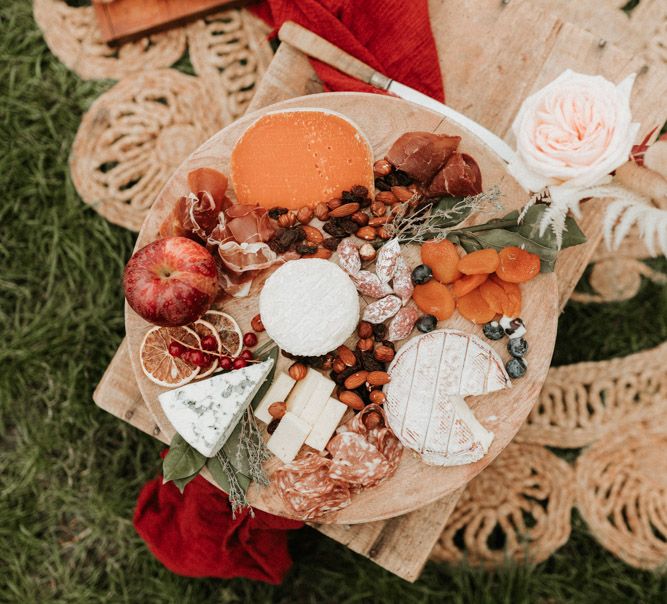 A wooden board is filled with cheese and cured meats. Photography by Anne-Sophie Benoit.