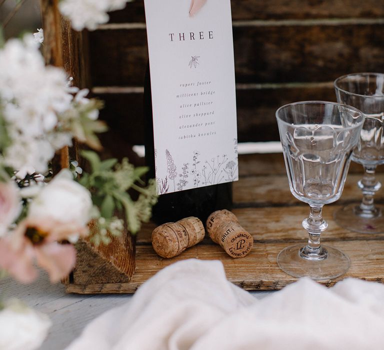 A wine bottle wedding table seating plan as a nod to the Loire Valley wine region