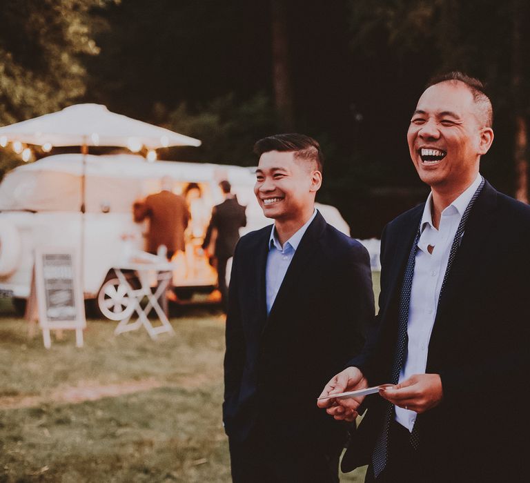 Wedding guests gather outdoors