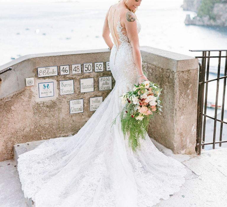 The bride wore a beautiful mermaid lace gown with a button back and embroidered floral details