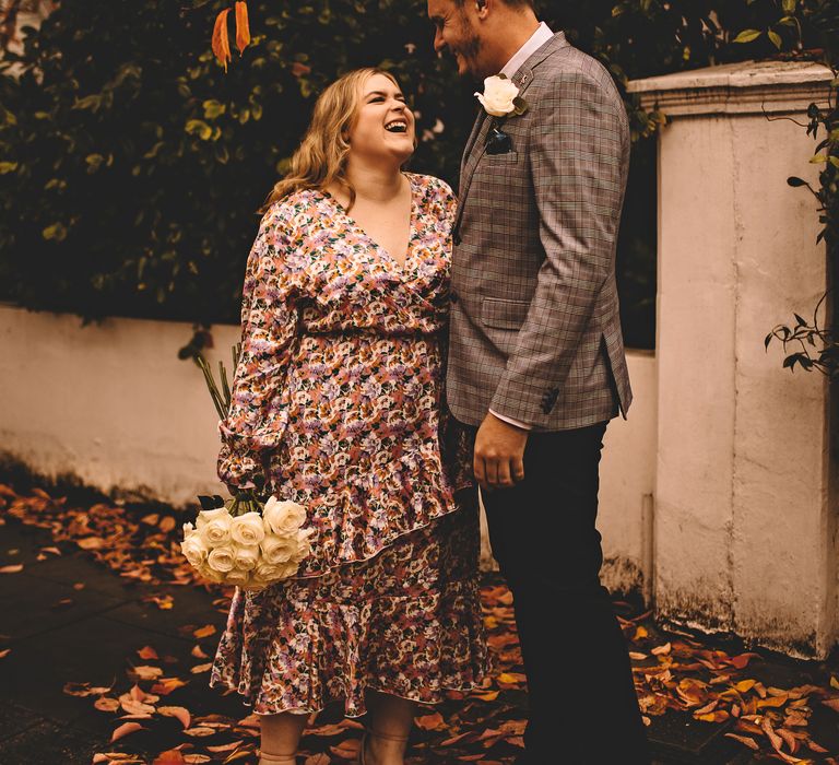 Bride looks up lovingly at groom as she wears ASOS floral wedding gown 