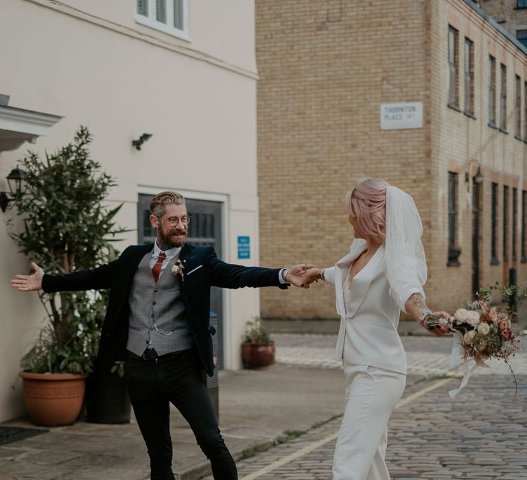 Bride and groom dancing in street at Marylebone wedding 