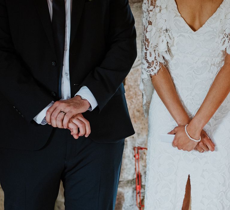 Close up image of bride & groom's hands standing side by side to show off their hands with wedding rings