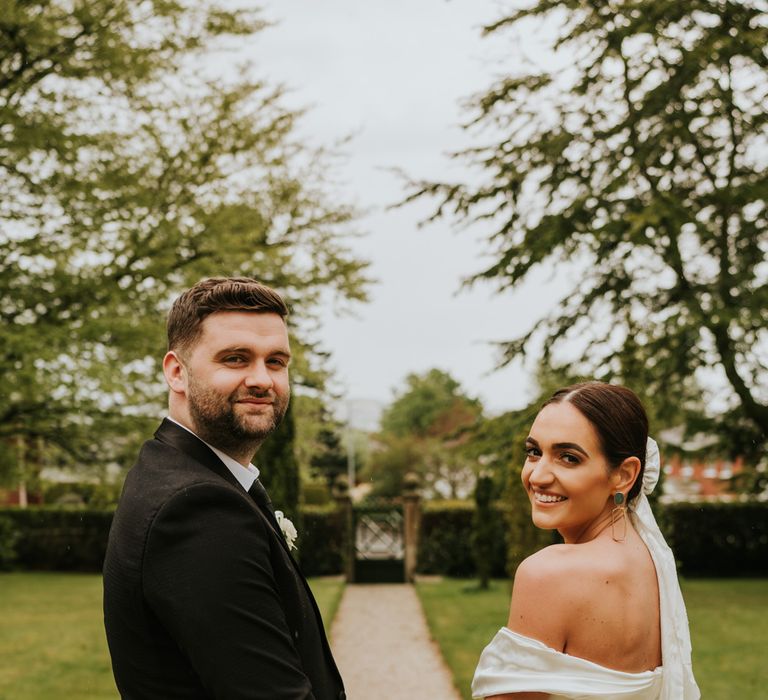 Bridal bun with veil and off the shoulder wedding dress for bride