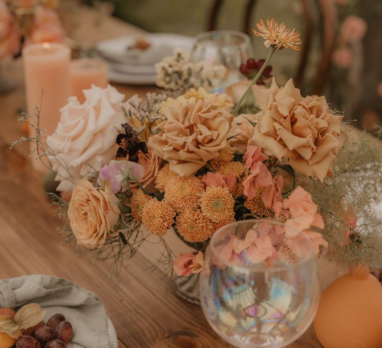 Pastel orange wedding flower arrangement with roses and dahlias 