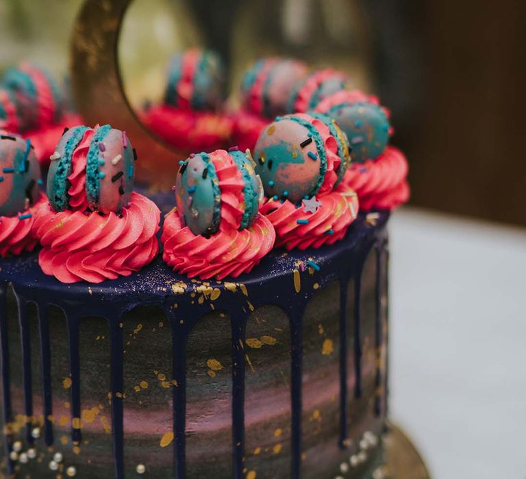 Drip wedding cake complete with pink frosting and multi-coloured macaroons 