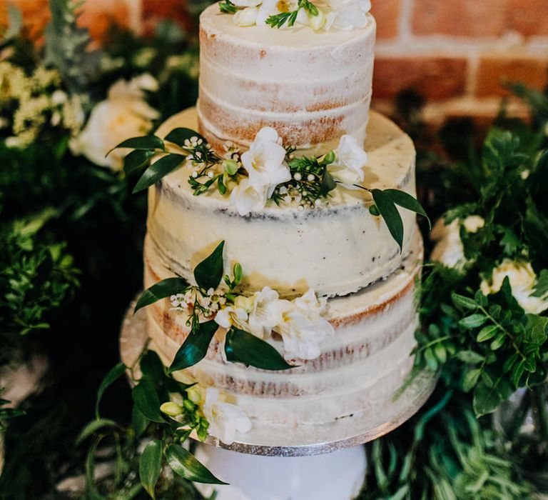 Semi naked wedding cake with laser-cut initial with cupids bow wedding cake topper 