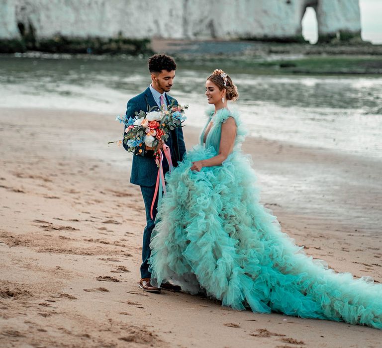 Botany Bay, Kent coastal wedding elopement with bride in a ruffle wedding dress and groom a wool suit 