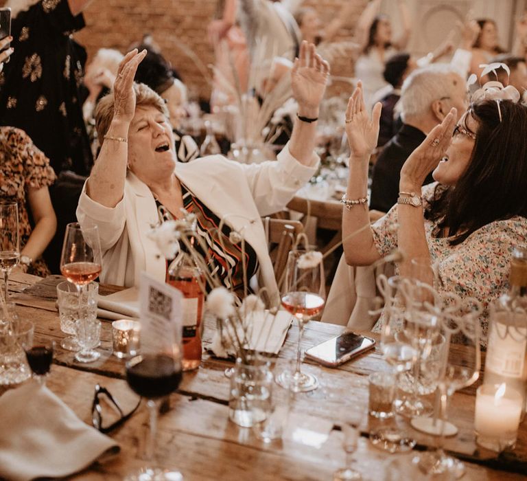 Wedding guests sing during wedding reception party