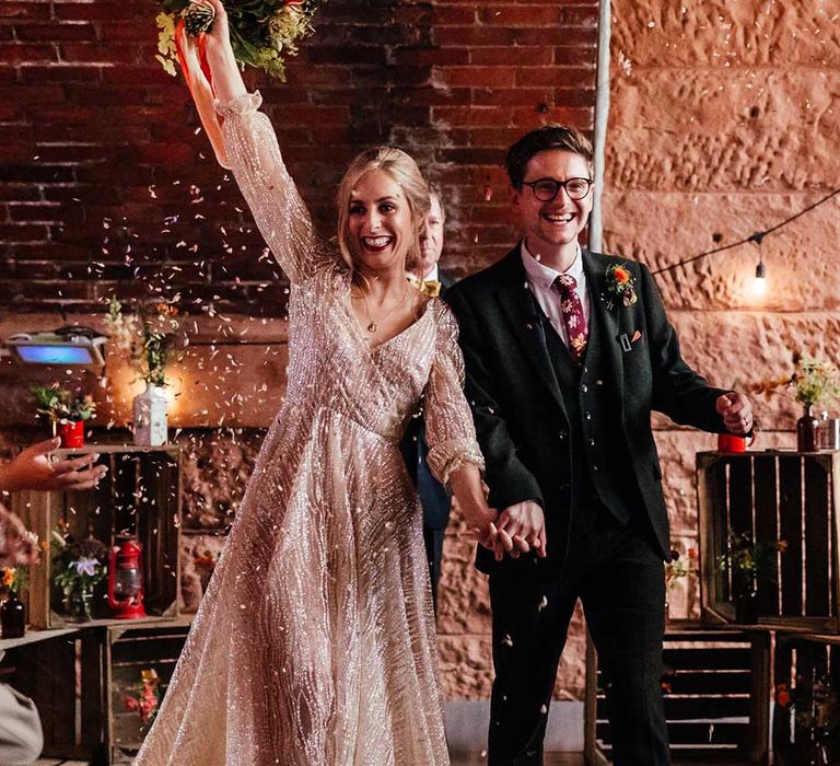 Bride & groom wave and celebrate after wedding ceremony