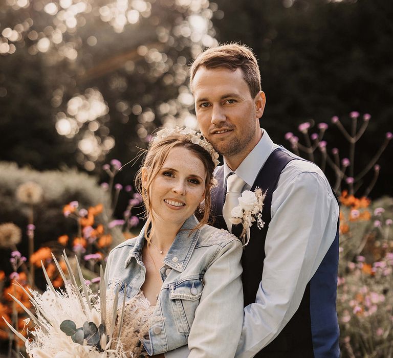 Groom wraps his arms around bride on their wedding day